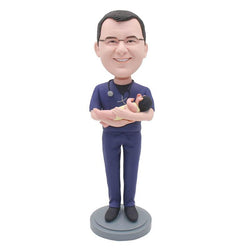 Personalized Bobblehead Obstetrician And Gynecologist Holding A Baby - Abobblehead.com
